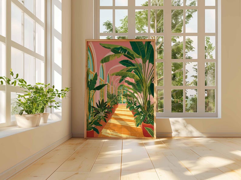 May include: A framed art print depicts a sunlit hallway lined with potted plants and archways. The artwork features a pink sky, orange floor, and green foliage. The scene is set in a room with a large window and potted plants on the windowsill.
