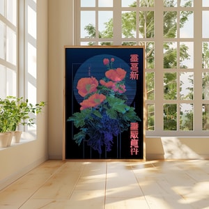 May include: A framed art print featuring a floral design with red and pink flowers, green leaves, and blue accents against a dark background. The artwork includes Japanese text and is displayed in a well-lit room with a window.