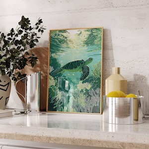 May include: A framed art print featuring a green sea turtle swimming underwater. The artwork has a gold frame and depicts the turtle amidst coral and sunlight filtering through the water. The color palette is dominated by greens and blues.