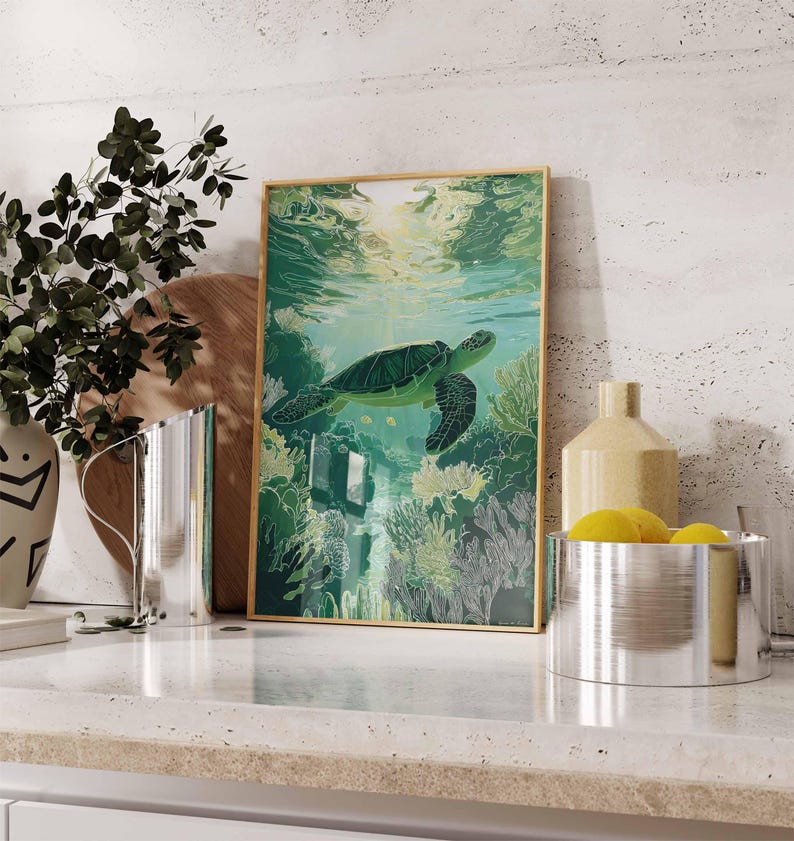 May include: A framed art print featuring a green sea turtle swimming underwater. The artwork has a gold frame and depicts the turtle amidst coral and sunlight filtering through the water. The color palette is dominated by greens and blues.