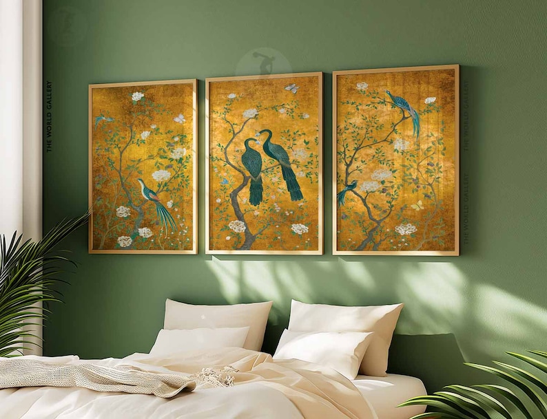 May include: Three framed prints with a gold background and a floral design featuring birds. The birds are blue and green with long tails. The prints are set against a green wall.