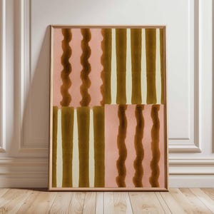 May include: Framed abstract art print featuring a geometric design. The artwork displays a pattern of vertical stripes and wavy lines in shades of brown, cream, and pink. The print is encased in a wooden frame, adding a touch of warmth to the piece.