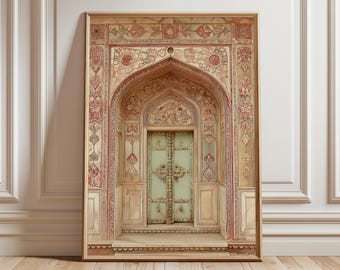 May include: A framed print depicting an ornate archway and door. The archway is beige with red and pink floral patterns. The door is light green with metal hardware. The print is in a wooden frame and rests on a wooden floor.