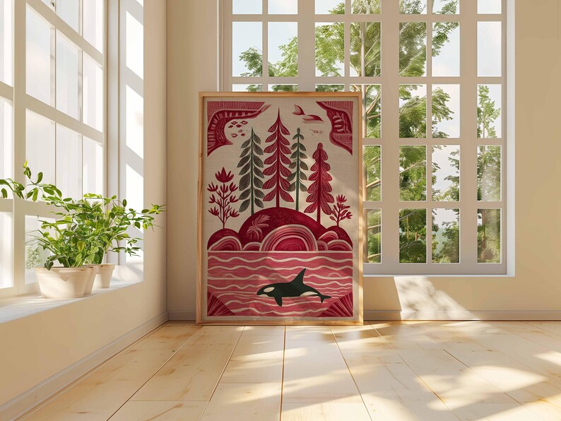 May include: A framed art print featuring a stylized landscape with a red and green color palette. The artwork depicts trees, hills, and an orca in the water. The print is displayed in a room with a window and plants.