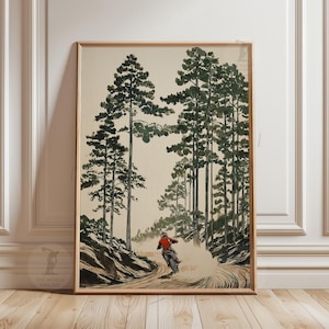 May include: A framed print showing a motocross rider on a dirt track in a forest. The artwork features tall green trees and a rider in red, creating a dynamic scene. The World Gallery logo is visible in the bottom left corner.