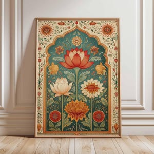 May include: A framed floral art print featuring a central teal archway design with a large red lotus flower and other colorful flowers. The artwork has a vintage aesthetic with a wooden frame and is displayed against a white wall and wooden floor.