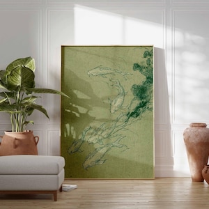 May include: A framed art print featuring a green and white illustration of koi fish swimming. The artwork is displayed in a room with a plant, ottoman, and decorative vases. The print has a gold frame.
