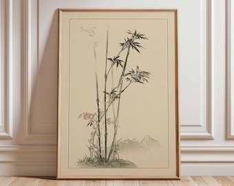 Puede incluir: Una impresión enmarcada que presenta una ilustración de estilo japonés de tallos de bambú con hojas verdes y flores rosas. La obra de arte incluye una cordillera en el fondo, todo sobre un fondo beige. El marco es de color marrón claro.