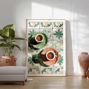 May include: A framed art print featuring two cups of coffee on saucers, one green and one coral, set against a backdrop of patterned tiles. The scene is in a bright room with a plant, ottoman, and decorative vases.