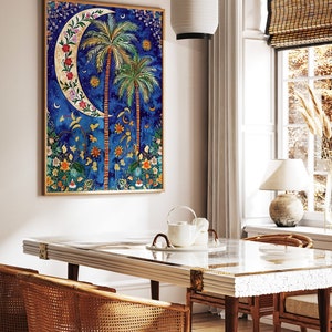 May include: A framed painting of a crescent moon with palm trees and flowers on a blue background. The painting is hanging on a white wall above a wooden table with two wicker chairs.