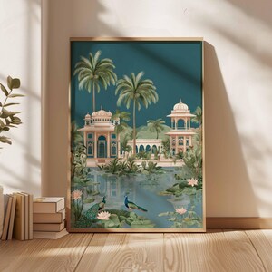 May include: Framed art print featuring a serene landscape with a teal sky and a reflective body of water. The artwork depicts ornate buildings, palm trees, and two peacocks. The color palette includes teal, beige, and green tones, creating a tranquil scene.