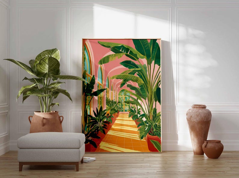 May include: A framed art print depicts a botanical scene with a pink arched hallway lined with lush green plants. The artwork is set against a white wall, with a potted plant, a gray ottoman, and terracotta vases in the foreground.