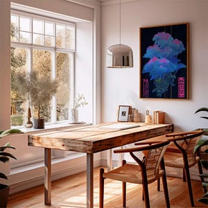 May include: A well-lit room with a wooden table and two chairs. A framed artwork with blue and pink hues hangs on the wall. A large window offers a view of trees. A silver pendant light hangs above the table.