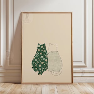 Puede incluir: L&aacute;mina art&iacute;stica enmarcada con dos gatos estilizados. Uno luce un estampado floral verde, el otro un dise&ntilde;o de cuadros. La obra se presenta sobre un fondo crema, creando una est&eacute;tica minimalista y encantadora.