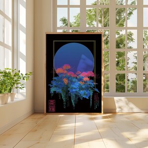May include: Framed art print featuring a stylized floral design with a blue orb against a black background. The artwork showcases a blend of blue, orange, and pink hues, with Japanese characters in the lower right corner. The print is displayed in a room with natural light.