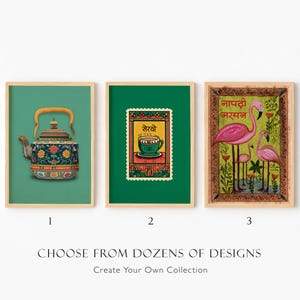 May include: Three framed wall art prints. The first shows a blue patterned teapot on a green background. The second features a postage stamp design with a teacup and the text "सेरवो". The third displays three pink flamingos with the text "नापटी जरमन".