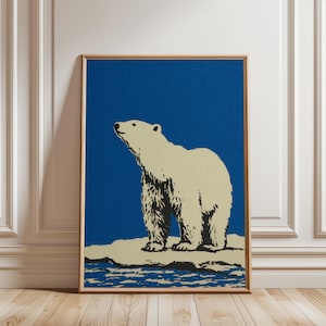 May include: A framed art print featuring a polar bear standing on ice against a blue background. The bear is depicted in cream and black, with a detailed fur texture. The artwork is in a wooden frame, suitable for wall decor.