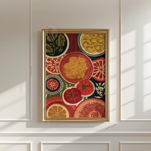 May include: A framed art print featuring a colorful, stylized illustration of Italian food. The artwork includes plates of pasta, tomatoes, and citrus fruits in shades of red, orange, yellow, and green. The print is in a gold frame.