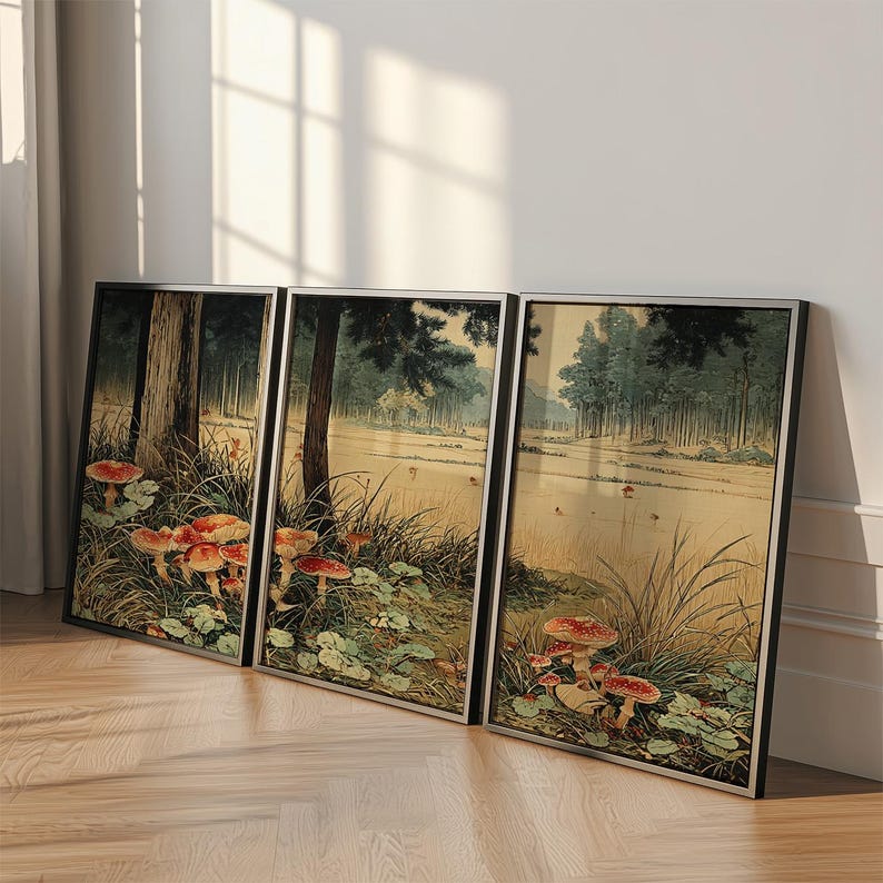 May include: Three framed art prints depicting a forest landscape with red-topped mushrooms. The artwork uses a vintage style, with muted greens, browns, and yellows. The frames are black with silver trim, adding a touch of elegance to the nature-inspired art.