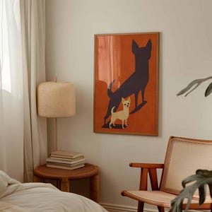 May include: A framed art print featuring a chihuahua dog with a dark shadow on an orange background. The artwork is displayed in a bedroom setting, with a wooden frame and a neutral color palette. A lamp and chair are also visible.