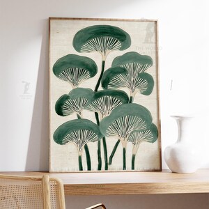 May include: A framed art print featuring a stylized illustration of mushrooms in shades of green and white. The artwork is set against a neutral background and is displayed on a wooden shelf with a white vase.