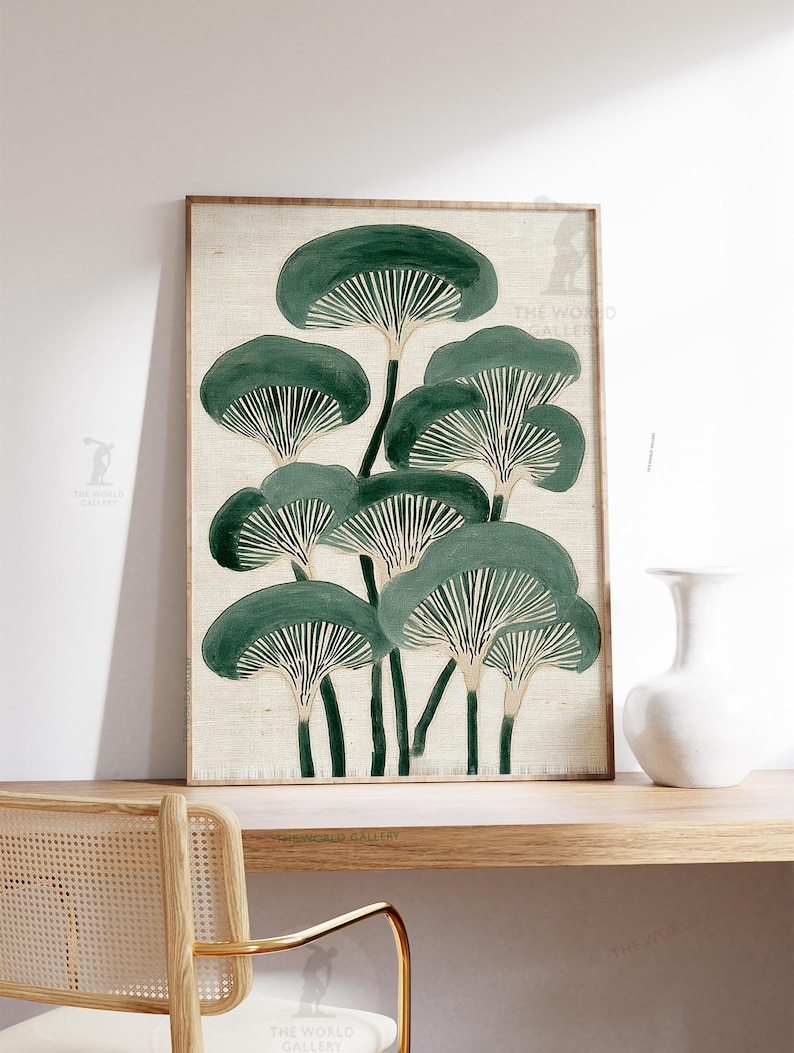May include: A framed art print featuring a stylized illustration of mushrooms in shades of green and white. The artwork is set against a neutral background and is displayed on a wooden shelf with a white vase.