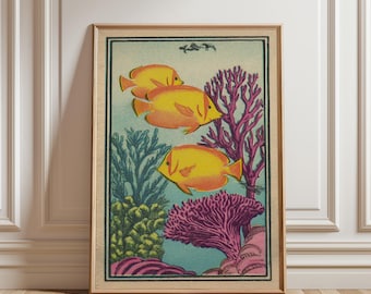 May include: A framed art print featuring three yellow fish swimming among coral and seaweed. The artwork has a vintage style with a light blue background and a wooden frame. The coral is pink and the seaweed is green.
