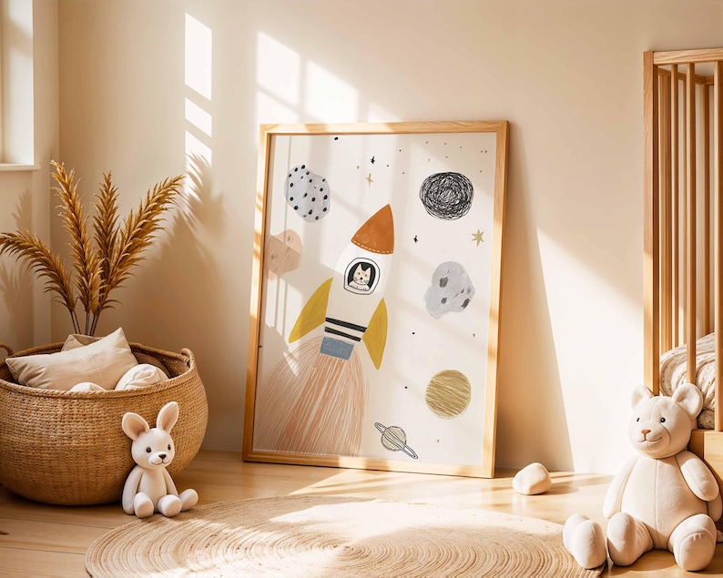 May include: A framed art print featuring a whimsical rocket ship with a cat pilot, surrounded by planets and stars. The illustration has a soft color palette with orange, yellow, and blue accents, perfect for a nursery or children's room.