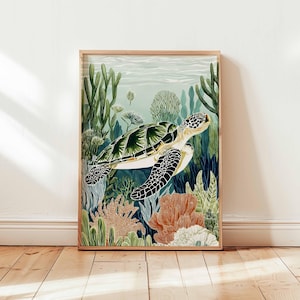 May include: A framed art print featuring a sea turtle swimming in a vibrant underwater scene. The turtle has a green and white shell with black markings. The artwork includes coral, seaweed, and other aquatic plants in shades of green, orange, and blue.