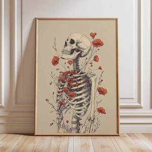 May include: A framed art print featuring a detailed illustration of a human skeleton with red poppy flowers growing through the rib cage. The artwork has a vintage aesthetic with a beige background and a wooden frame.