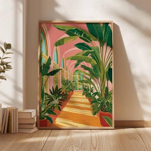 May include: A framed art print depicts a sunlit botanical garden hallway with arched doorways and lush green plants in red pots. The walls are a soft pink, and the floor is a warm orange. The artwork is in a wooden frame.