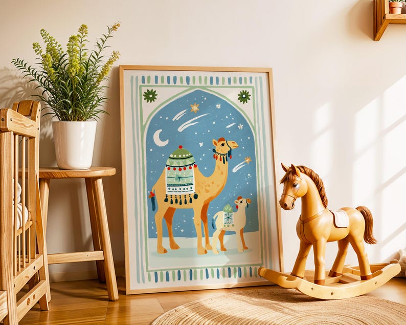 May include: A framed art print featuring two camels in a desert scene with a blue sky, stars, and a crescent moon. The artwork is in a wooden frame and is displayed next to a wooden rocking horse and a potted plant.