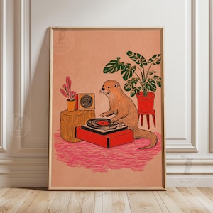 May include: A framed art print featuring an otter operating a record player. The otter is brown, and the record player is red. A speaker, plants, and a pink rug complete the scene. The artwork has a vintage, whimsical style.