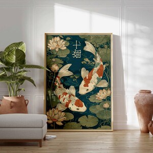 May include: A framed art print featuring two koi fish swimming in a pond with lily pads and lotus flowers. The artwork has a teal background and a gold frame. Japanese characters are at the top of the print.