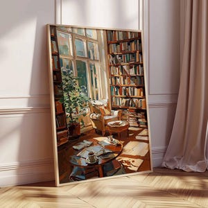 May include: A framed art print depicts a cozy library scene. Sunlight streams through a large window, illuminating bookshelves filled with books, a small table with a coffee cup, and a comfortable armchair. The artwork has warm, inviting tones.