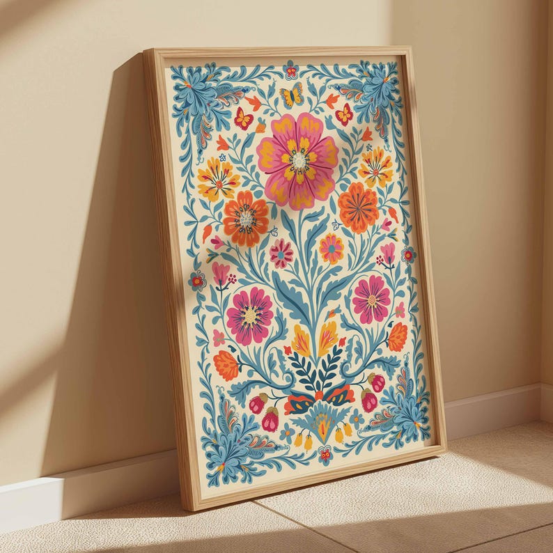 Op de afbeelding: Een ingelijst print met een kleurrijk bloemenontwerp. De bloemen zijn roze, oranje, geel en blauw. De achtergrond is cr&egrave;mekleurig.