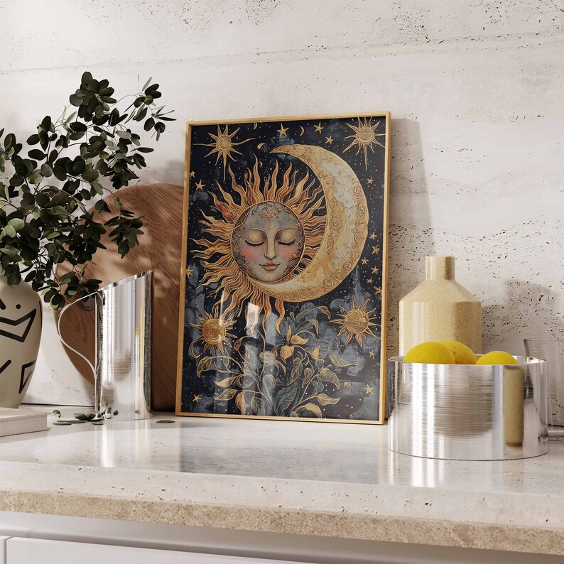 May include: A framed print of a celestial scene with a crescent moon and a sun with a face. The background is a dark blue with gold stars and a floral design.