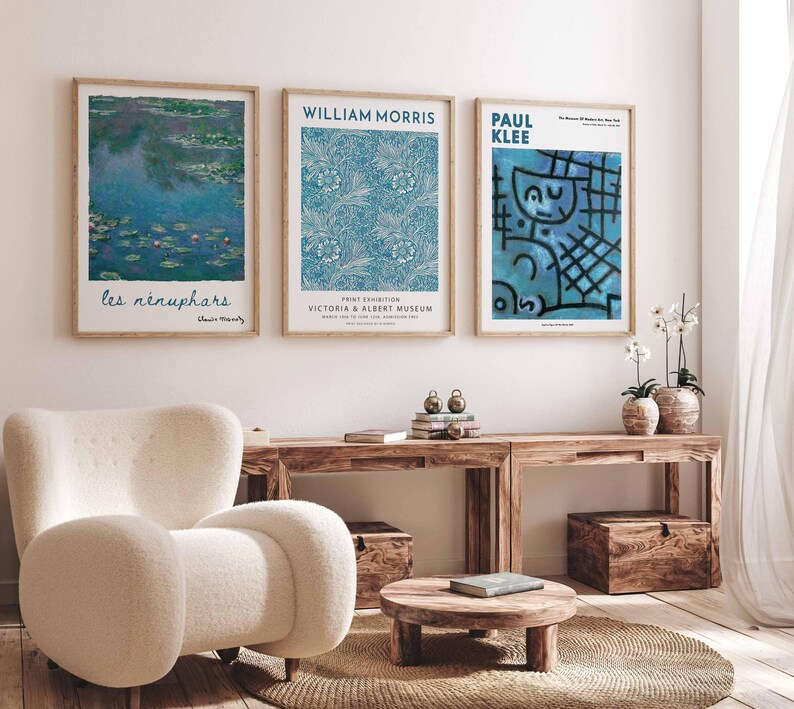 May include: Three framed art prints displayed on a white wall. The prints showcase artwork by Claude Monet, William Morris, and Paul Klee. The Monet print shows water lilies, the Morris print has a blue floral pattern, and the Klee print is abstract.
