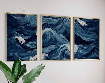 May include: Three framed wall art pieces depicting ocean waves in shades of blue and white. The artwork features dynamic brushstrokes, capturing the movement of the water. Each piece is framed in a gold-colored frame, adding a touch of elegance to the coastal theme.