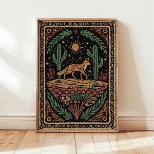 May include: A framed art print featuring a desert scene with a fox, cacti, and sun. The artwork uses a color palette of orange, green, and black. The fox is walking across a sandy landscape, with a detailed border.