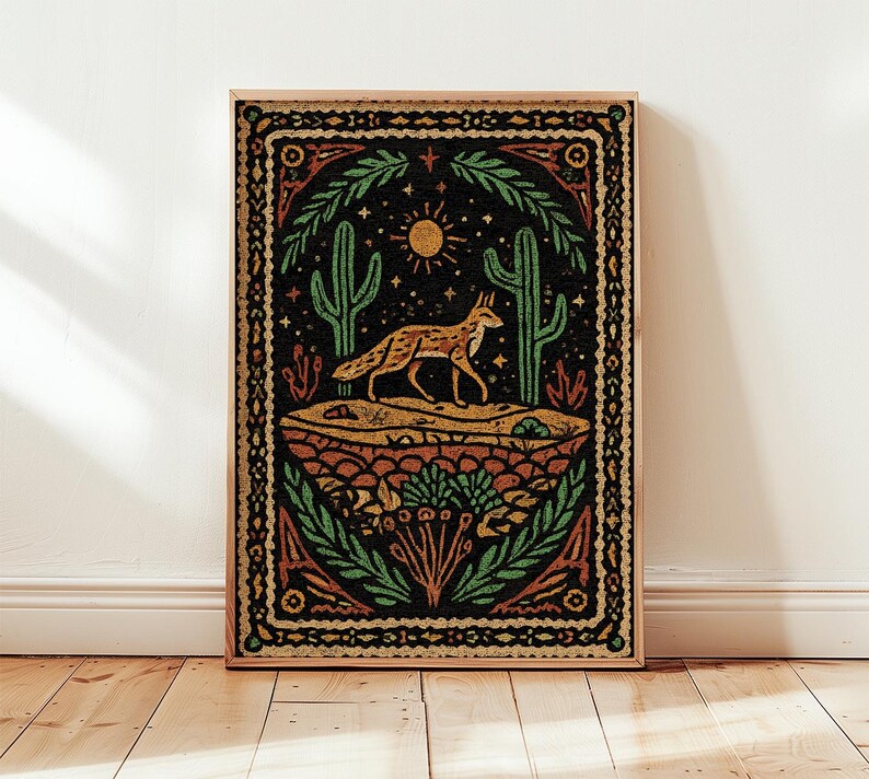 May include: A framed art print featuring a desert scene with a fox, cacti, and sun. The artwork uses a color palette of orange, green, and black. The fox is walking across a sandy landscape, with a detailed border.