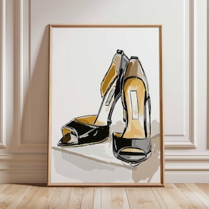 May include: An art print depicting a pair of black high-heeled sandals with gold and beige detailing. The illustration style is sketch-like, with strong black outlines and a minimalist background. The framed artwork is displayed on a white wall.