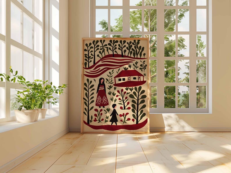 Op de afbeelding: Een ingelijste folk art print met een rood en zwart landschap met gestileerde figuren, bomen en een huis. Het kunstwerk wordt tentoongesteld in een lichte kamer met een raam en potplanten, wat een warme en uitnodigende sfeer cre&euml;ert.