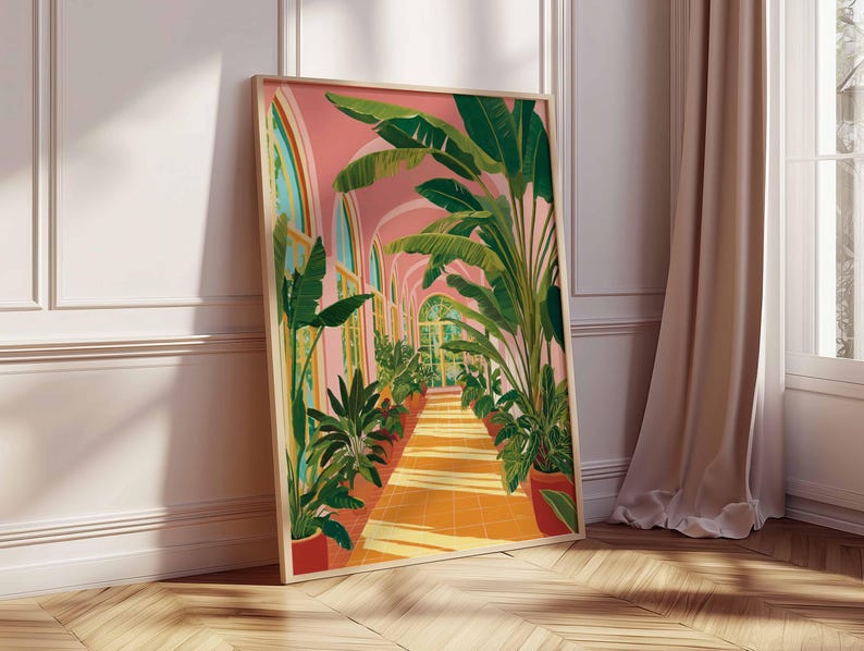 May include: A framed art print depicts a sunlit botanical scene. The artwork showcases a long corridor with arched windows, lined with potted plants and lush green foliage. The walls are a soft pink, and the floor is a warm orange hue. The frame is a light wood color.