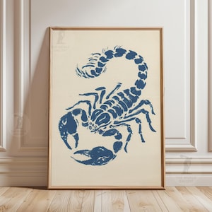 May include: Framed print of a blue scorpion illustration on a cream backdrop. The scorpion is shown with its claws raised and tail curved. The artwork is in a wooden frame, suitable for wall decor, ideal for a living room.