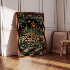 May include: A framed art print featuring a desert landscape with a fox. The artwork has a black background with a sun, cactus, and other desert plants. The fox is orange and brown, and the frame is brown.