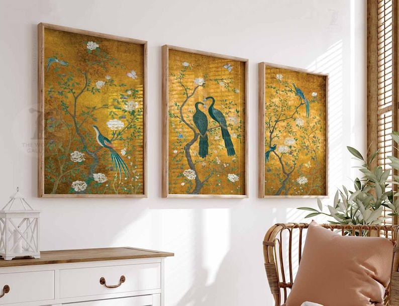 May include: Three framed prints with a gold background and a floral design. The prints feature birds and flowers in shades of blue, green, and white.