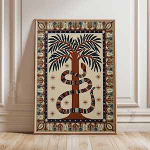 May include: Framed artwork depicting a tree with a snake wrapped around it. The artwork has a beige background, a dark blue border, and decorative floral and star patterns. The snake is brown and blue, with a stylized design.