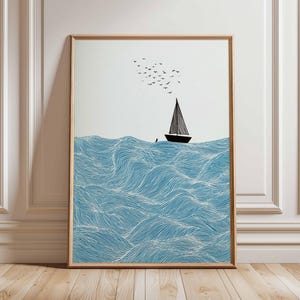 May include: Framed art print featuring a sailboat on a wavy sea. The waves are blue with white lines, and the boat is black with a triangular sail. A flock of birds flies above the boat, set against a white background.