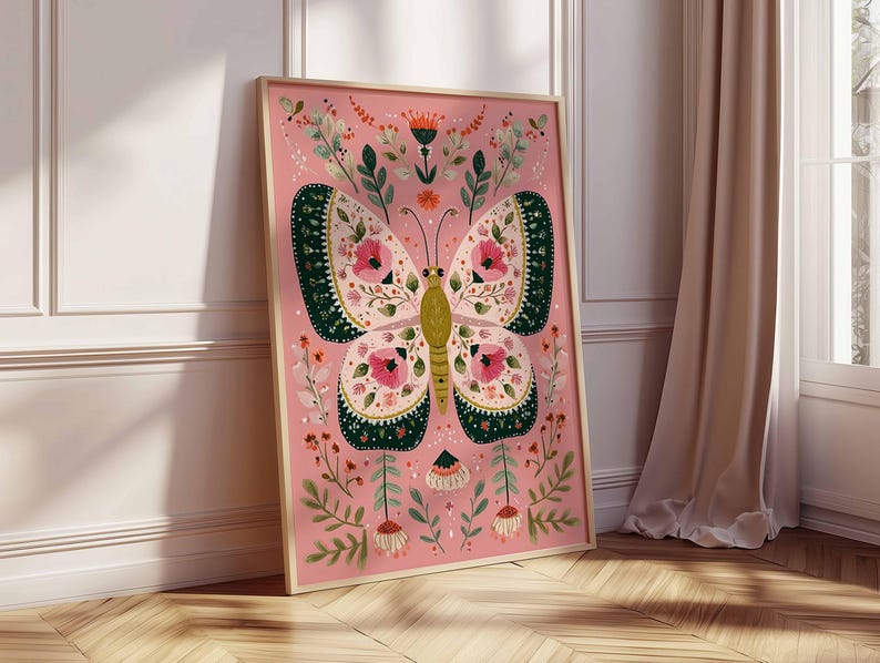 May include: A framed art print featuring a stylized butterfly with intricate floral patterns. The butterfly has pink, green, and yellow details against a pink background. The artwork is surrounded by additional floral elements and is displayed in a light wooden frame.